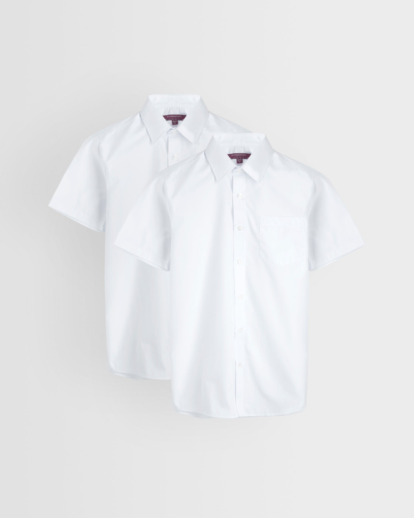 Two short-sleeved white shirts laid out flat on a white background, showcasing the collar and button-up front.
