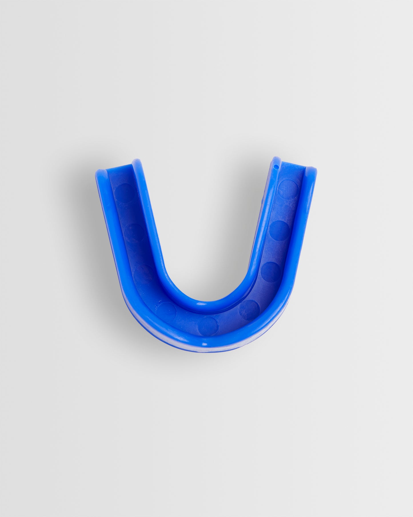 Top view of a blue mouthguard designed for sports protection, displayed on a white background.