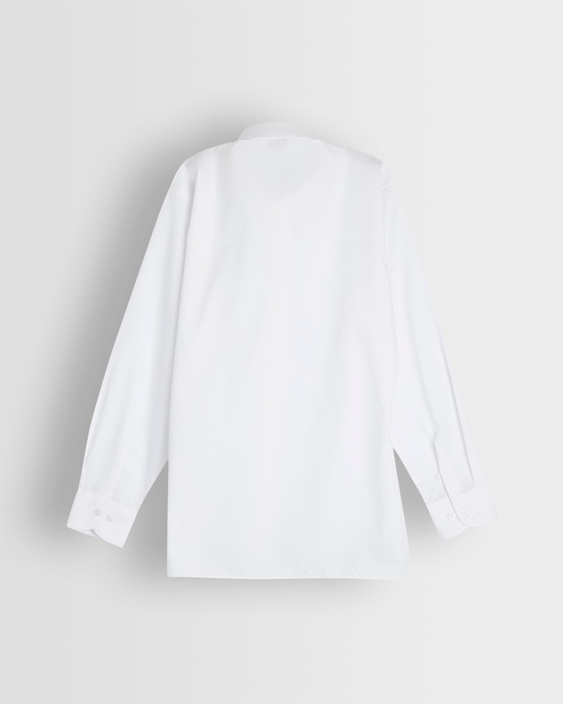 Back of long sleeved blouse on light grey background