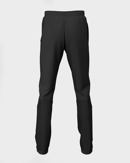 Back view of girls' black cricket trousers with a drawstring at the waist, deep side pockets, and a contrast stretch rib calf panel.