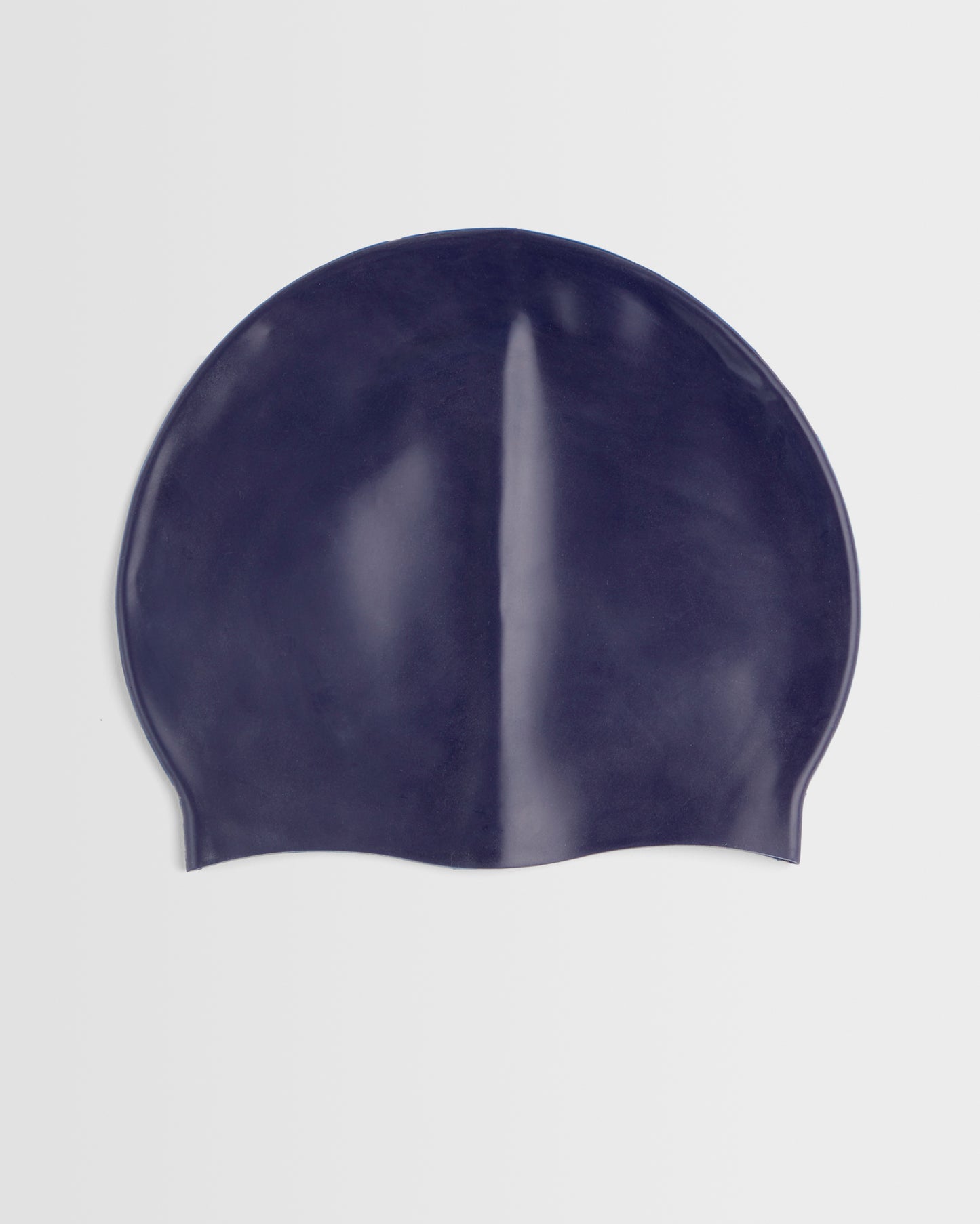 A navy silicone swimming cap placed on a white background.