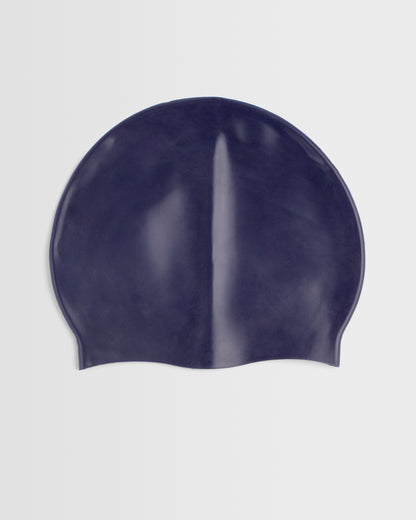 A navy silicone swimming cap placed on a white background.