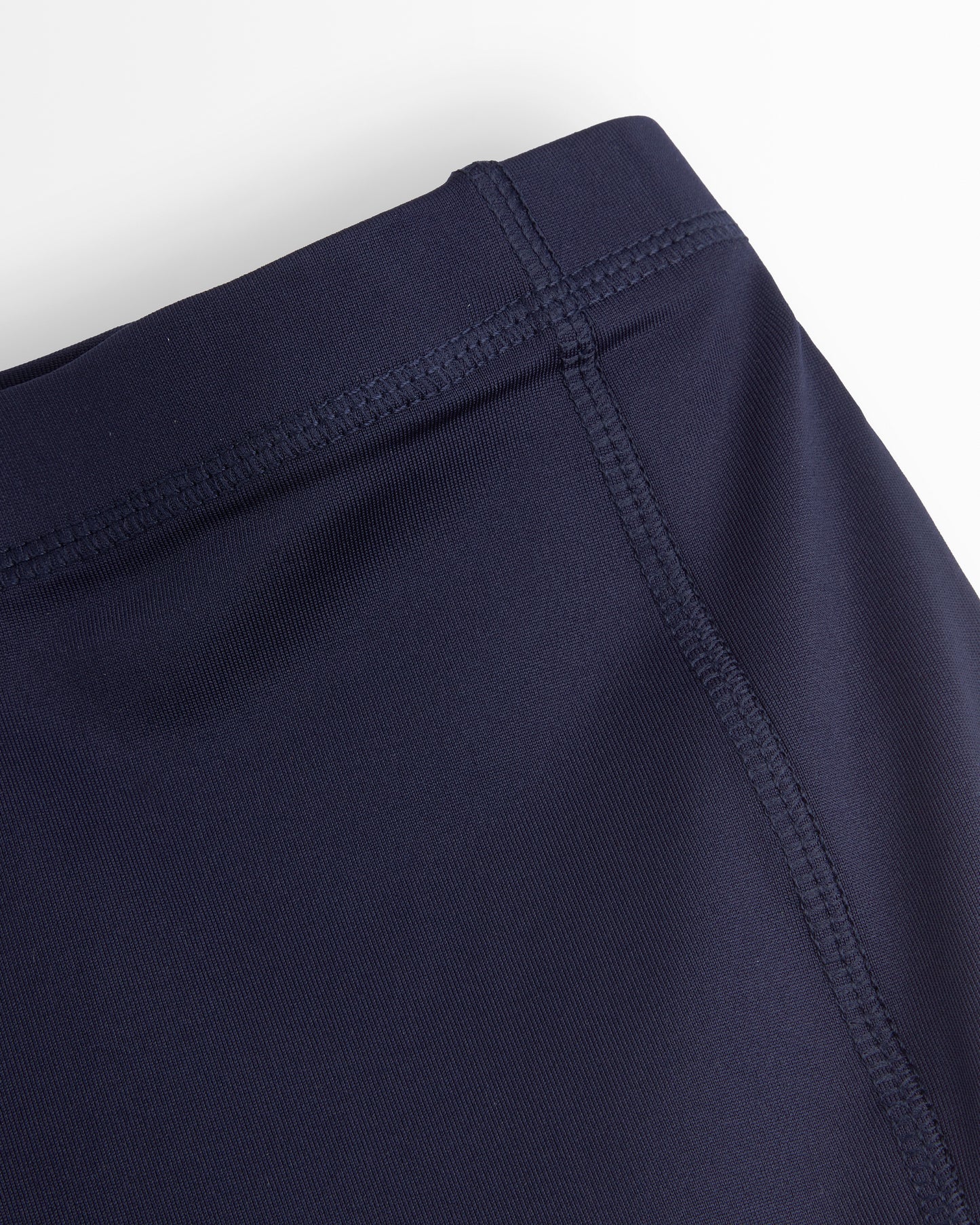 Navy blue shorts with a close-up of the waistband on a white background