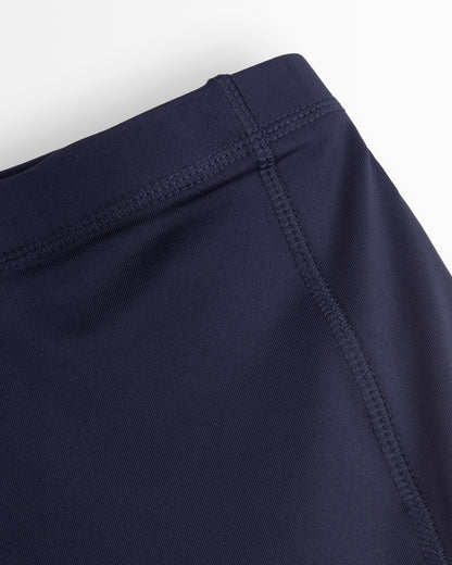 Navy blue shorts with a close-up of the waistband on a white background