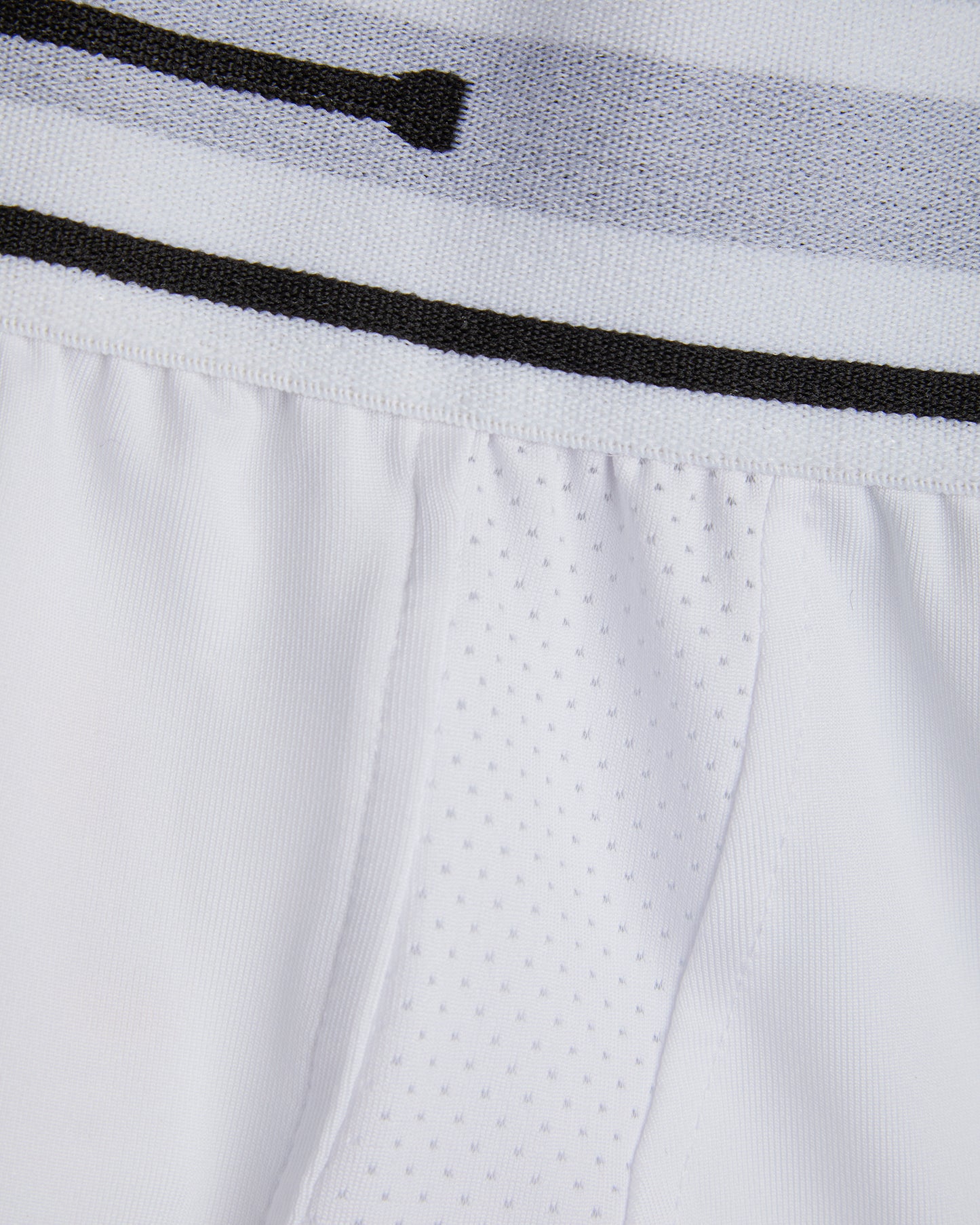 Close up of white cricket undershorts/trunks waist showing elastic waist and fabrics used