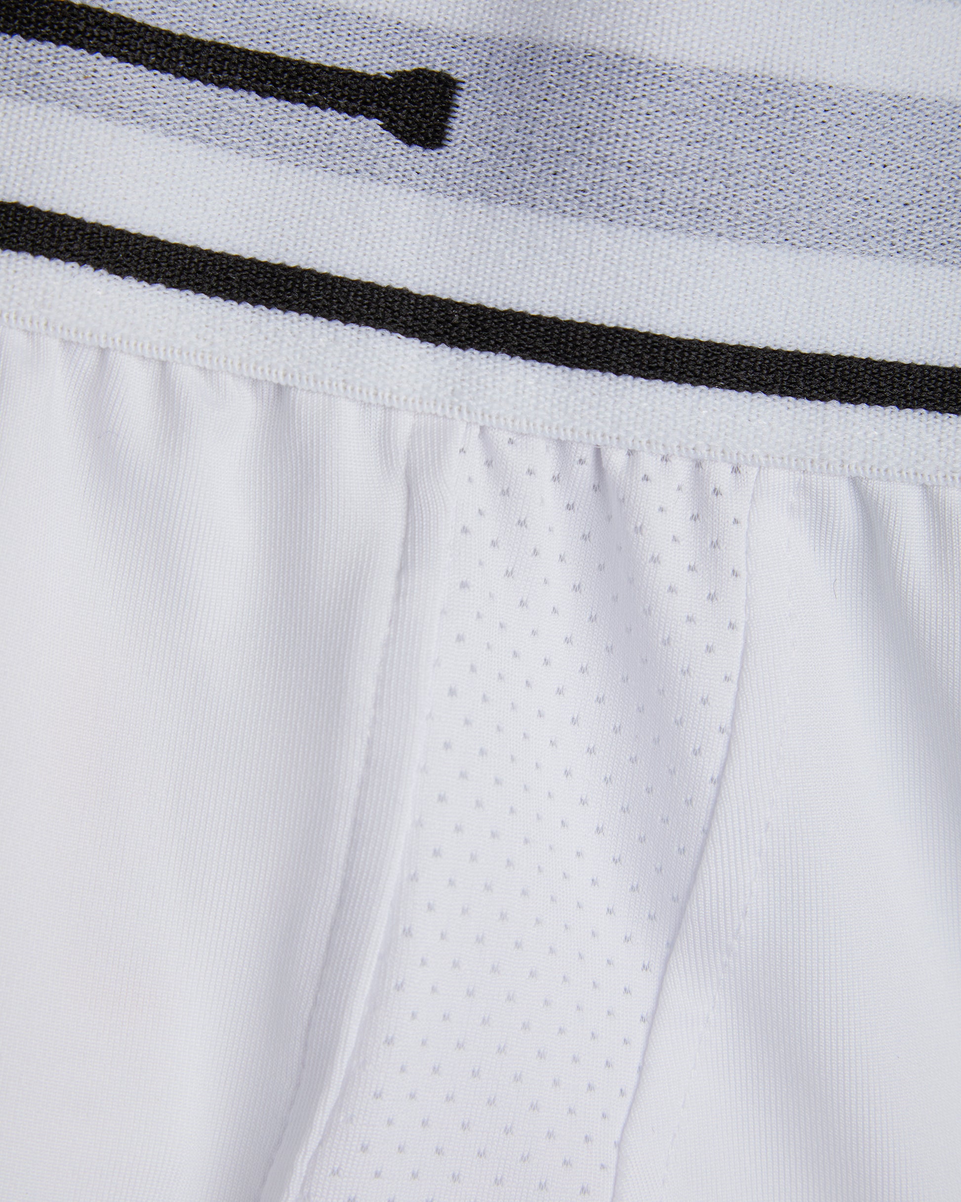 Close up of white cricket undershorts/trunks waist showing elastic waist and fabrics used