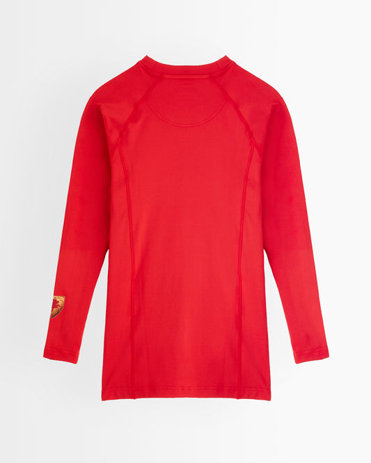 A red long-sleeve athletic baselayer with raglan sleeves, displayed flat against a light grey background.