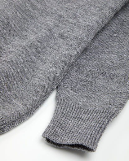 Close up of ribbed cuff on a grey unisex pullover.