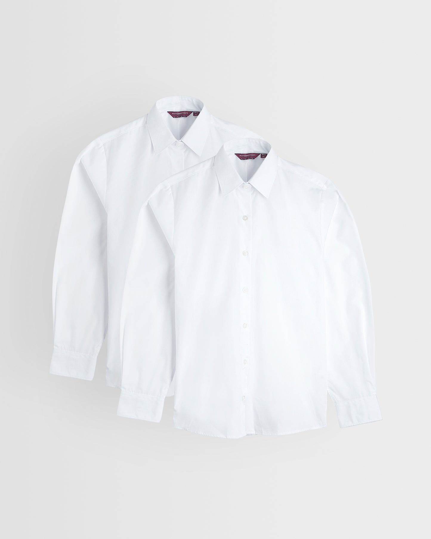 Two white long sleeve shirts laid out flat on a white background, standard collar, buttoned to the neck.