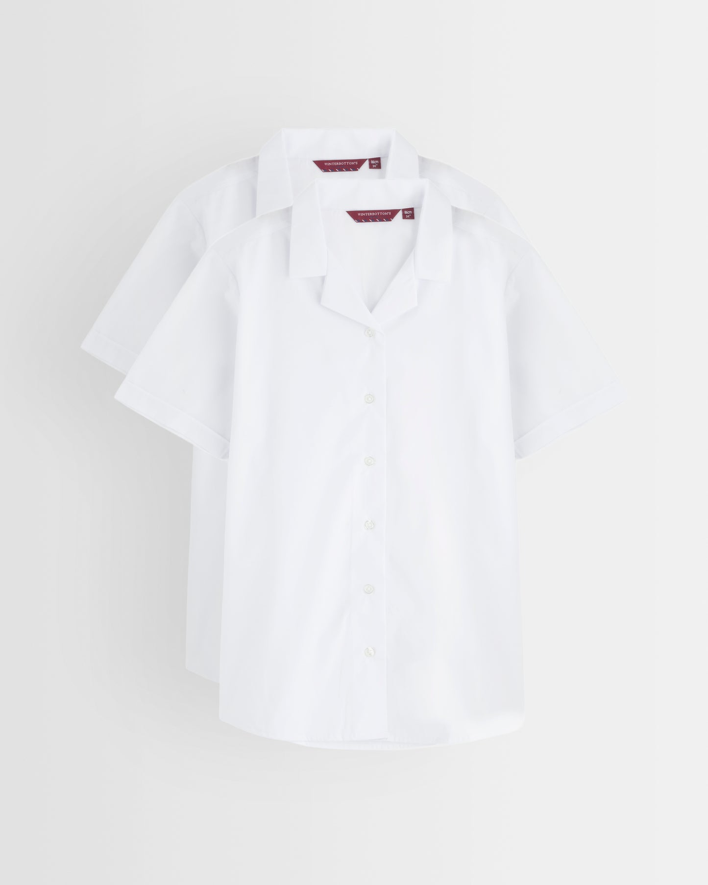 White blouse with revere collar on a light grey background