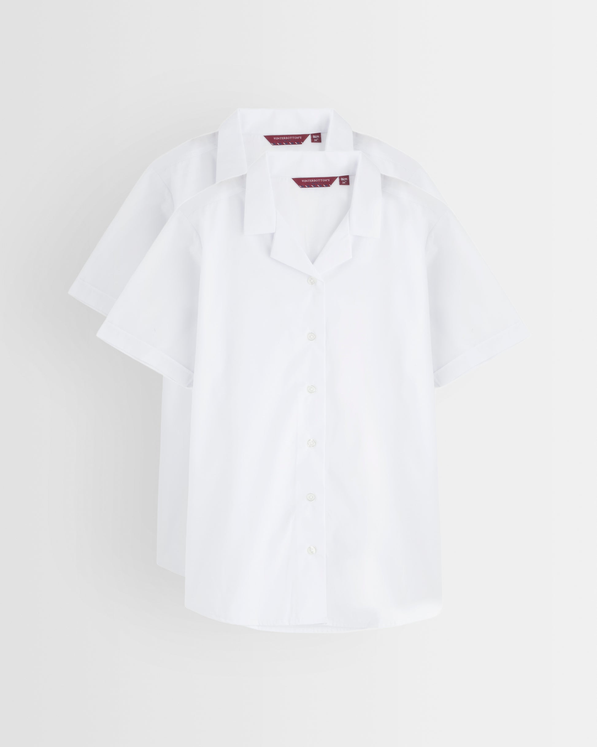 White blouse with revere collar on a light grey background