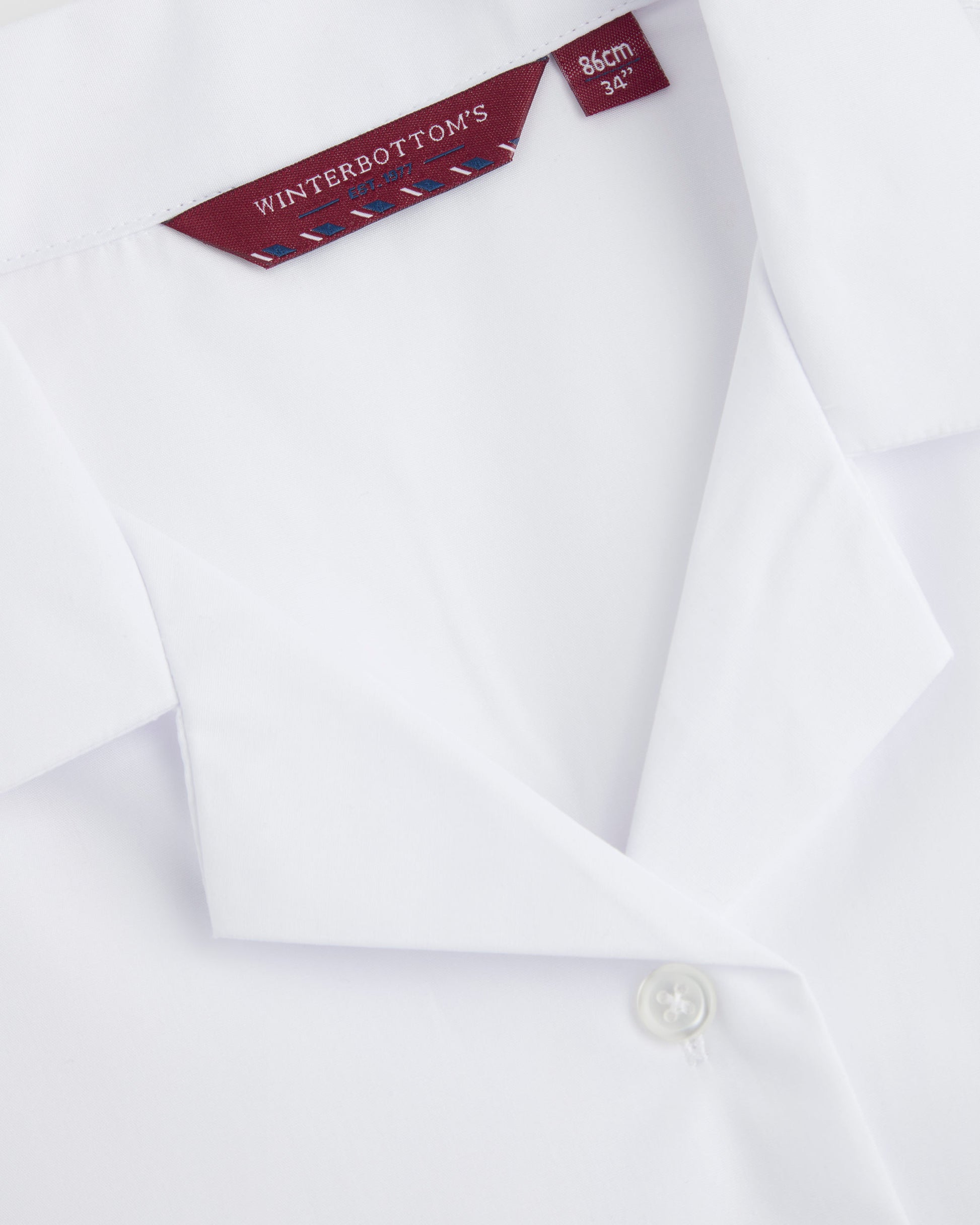 Close up of white revere-collar blouse with a brand and size label