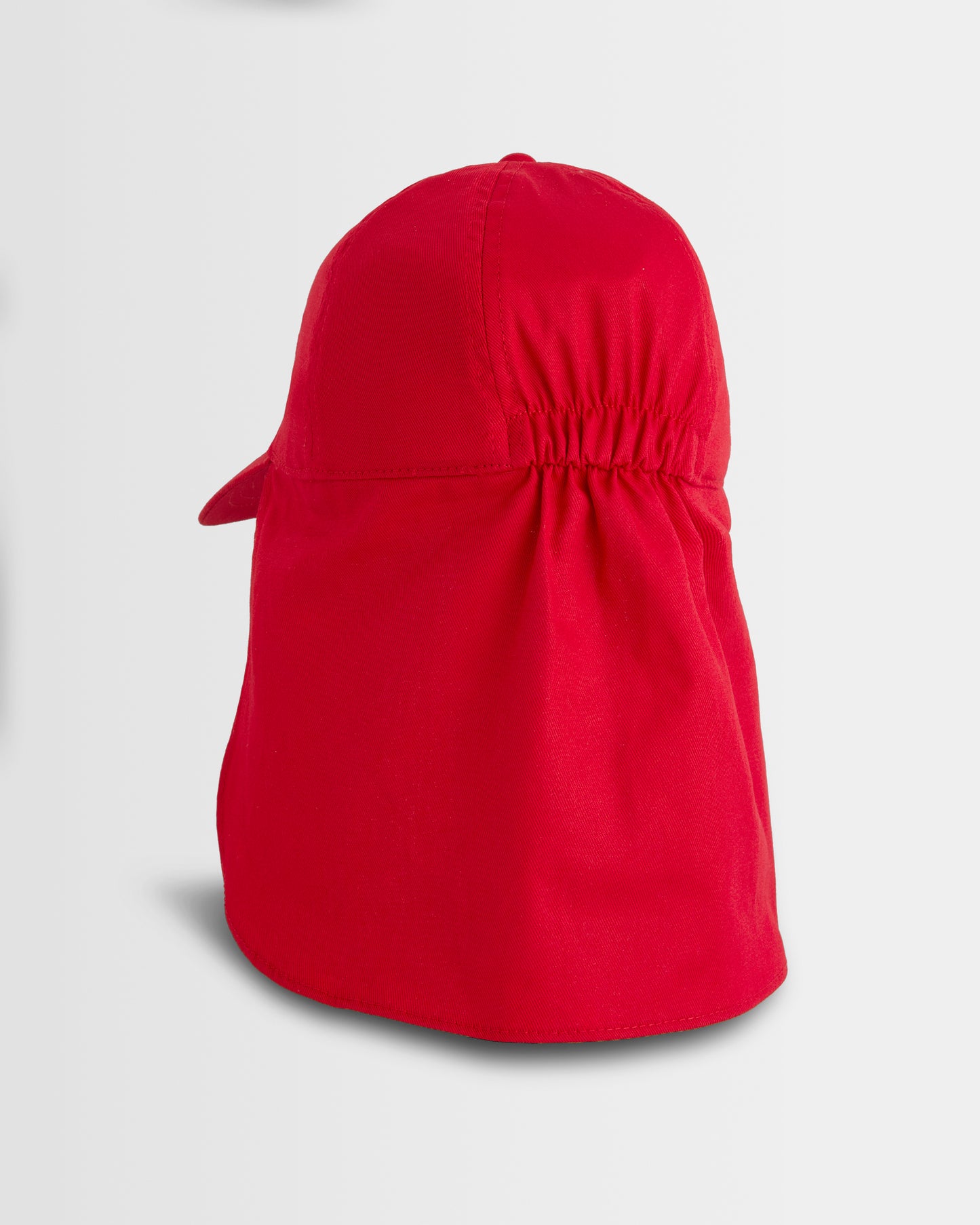 Red sun hat with a flap on a light grey background