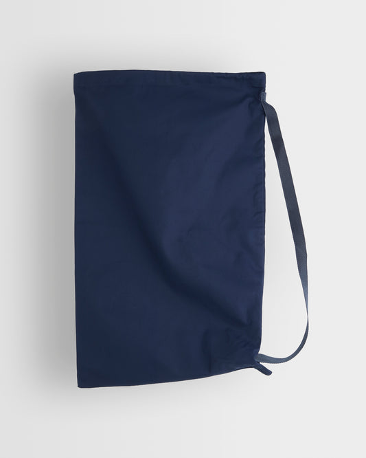 A navy blue drawstring bag with a long strap, shown against a light grey background.