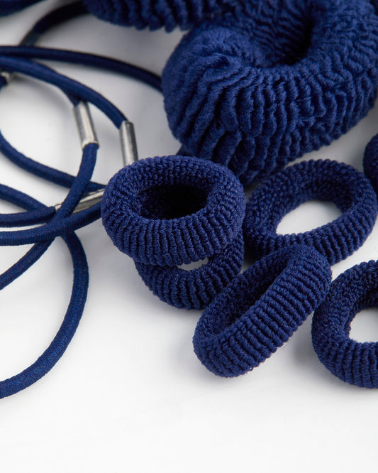 Navy hairbands, assorted types on a white background