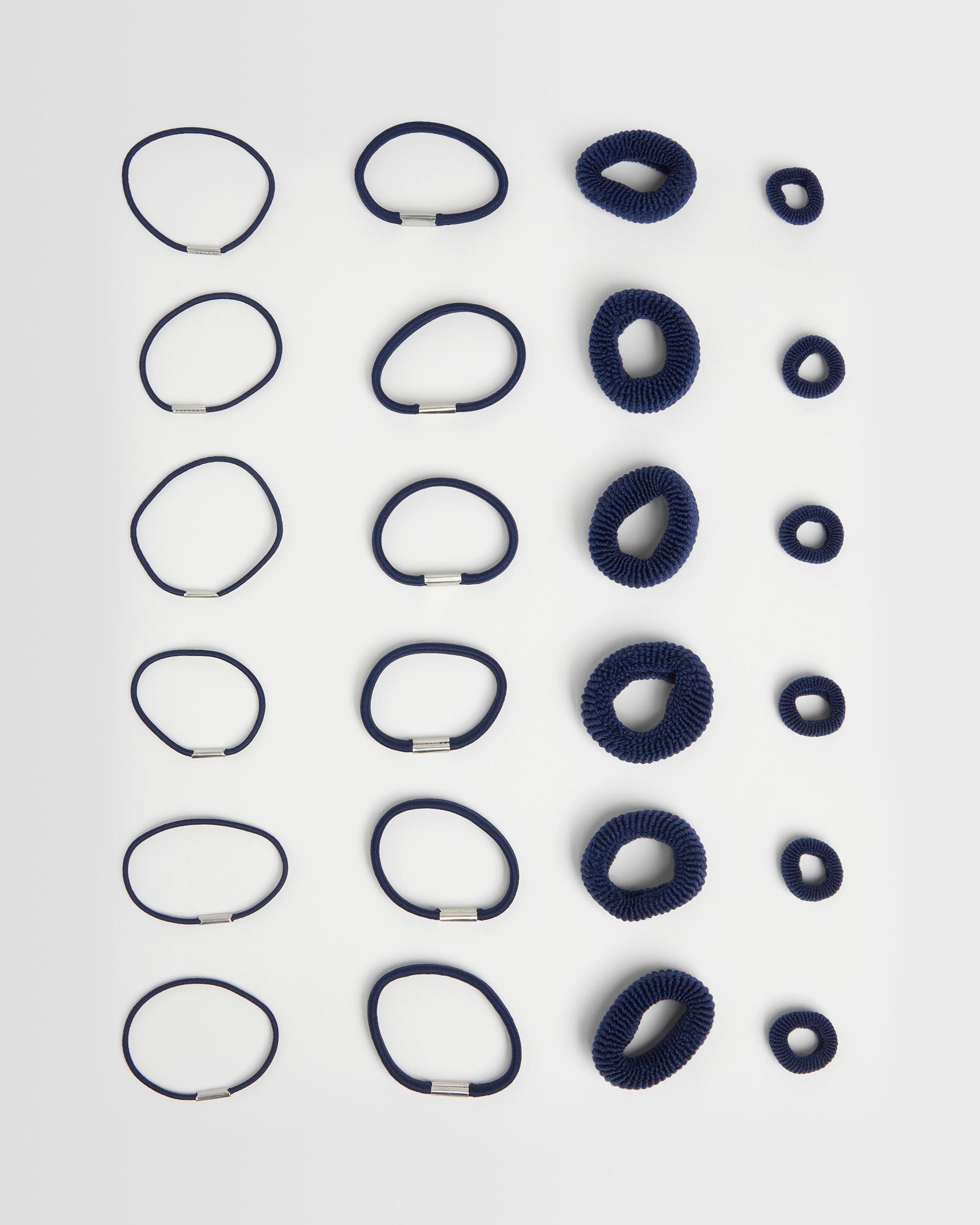 navy hair ties full amount (24) on a light grey background