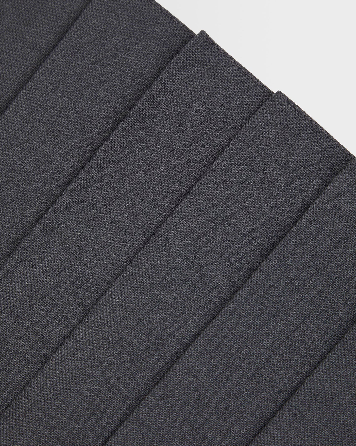 Close up of pleating on girls grey kilt