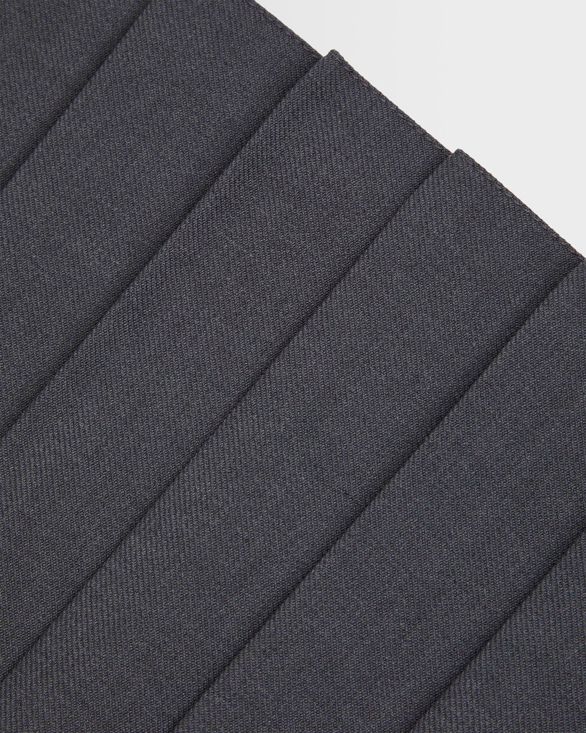 Close up of pleating on girls grey kilt