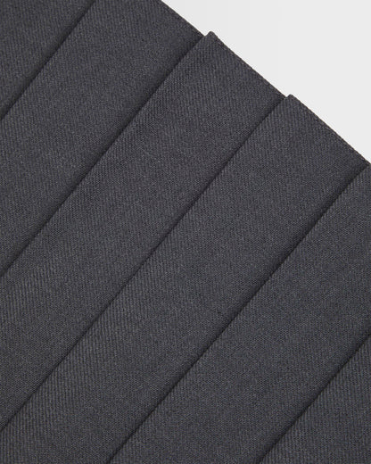 Close up of pleating on girls grey kilt