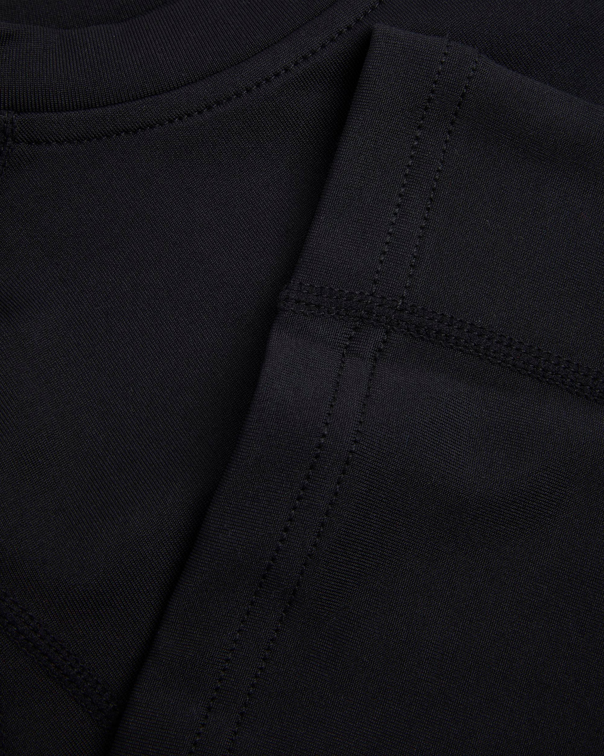 Close up of hem and seams of a black baselayer 