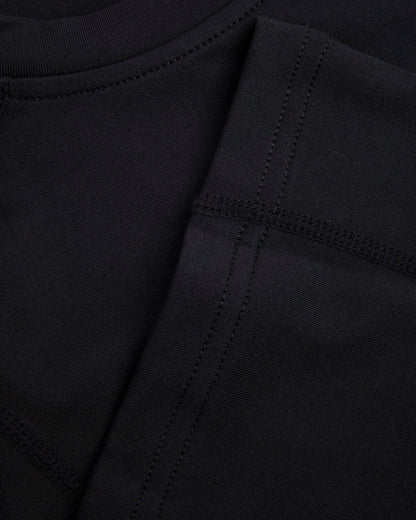 Close up of hem and seams of a black baselayer 