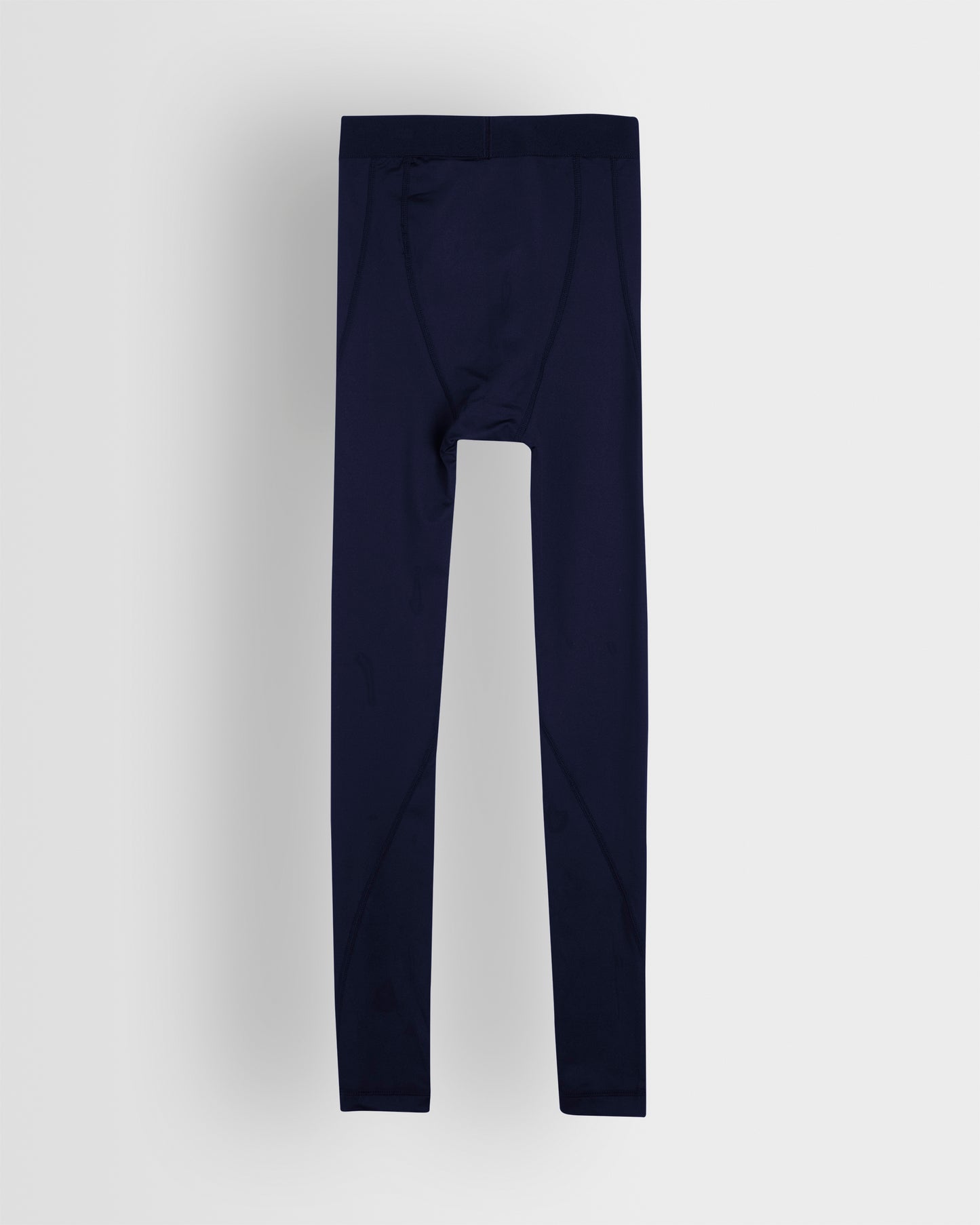Back shot of a pair of navy blue unisex base leggings for youth and adults