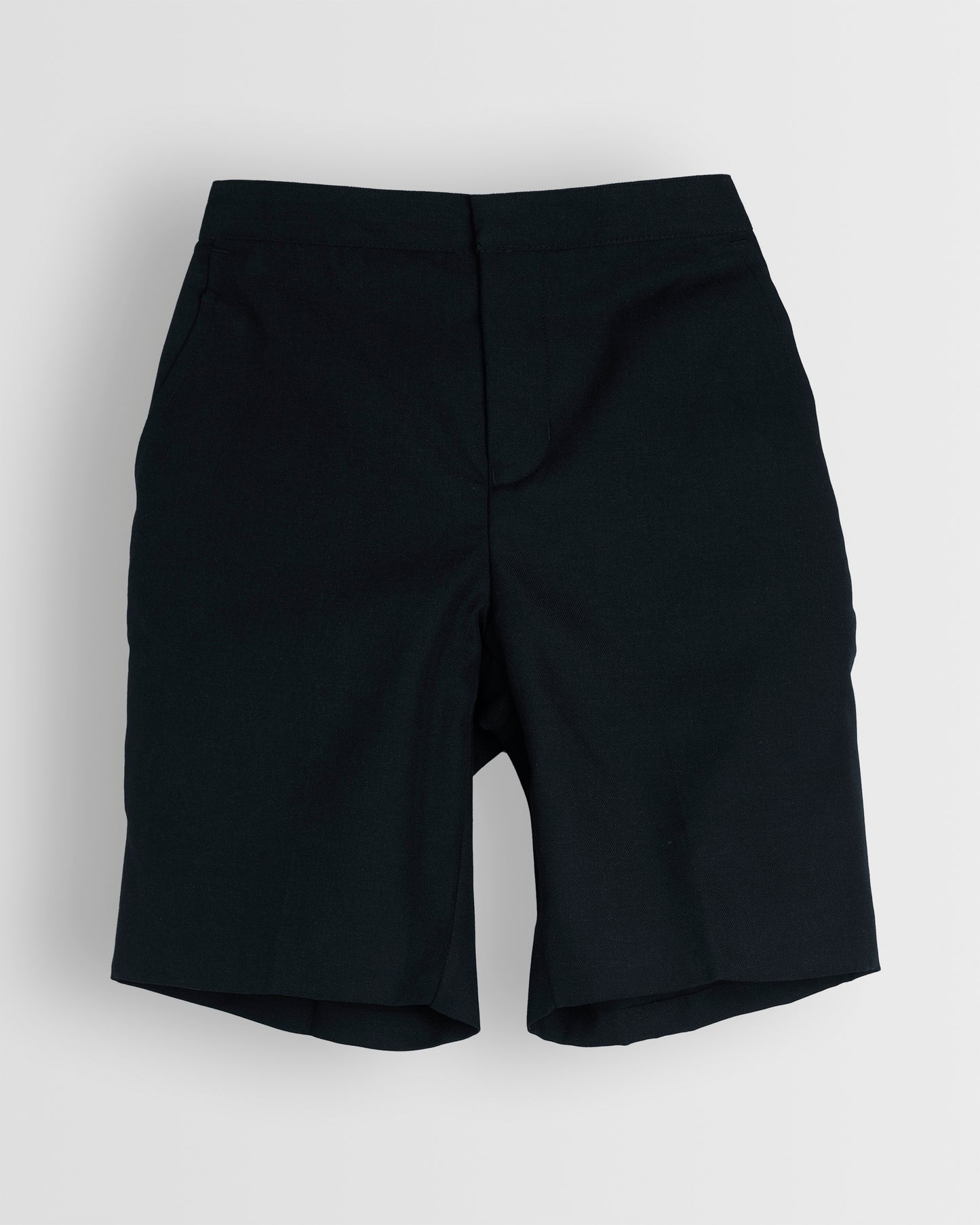 A pair of boys navy summer shorts with a half elasticated waist and single hook and bar fastening, waist size in inches, fully lined, no belt loops.