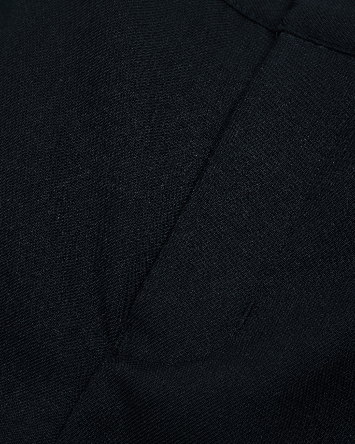 Close up view of boys navy summer shorts single hook and bar fastening