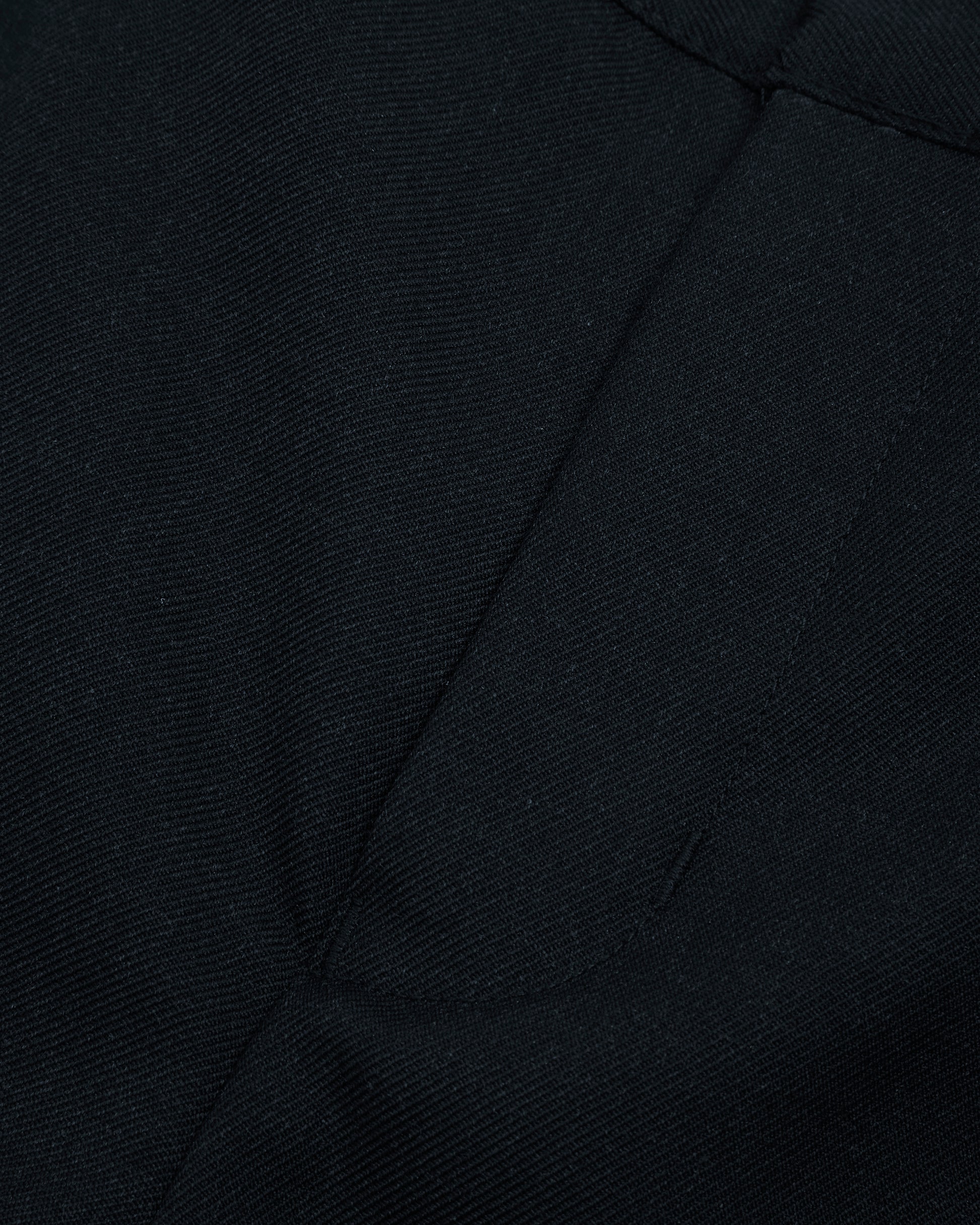 Close up view of boys navy summer shorts single hook and bar fastening