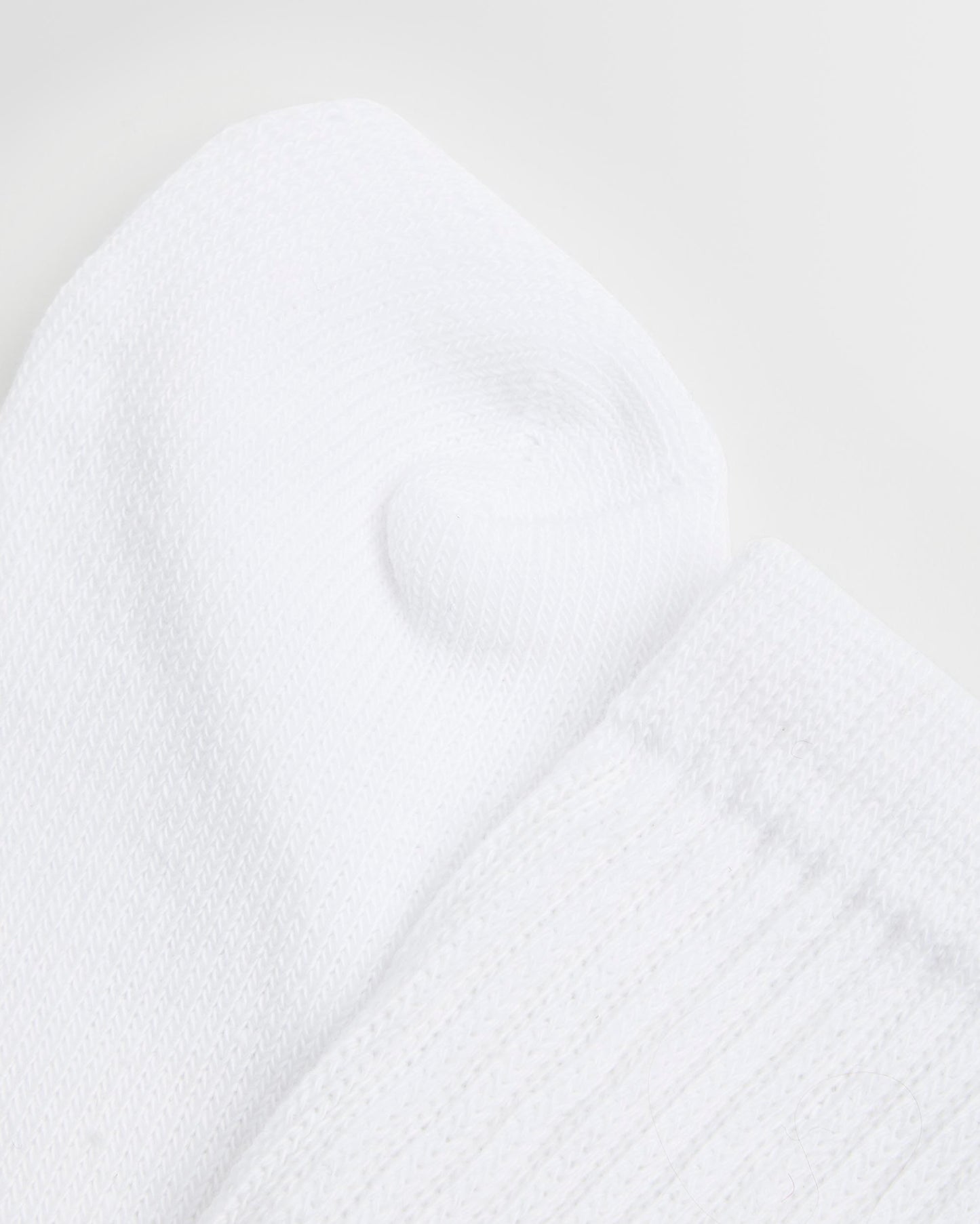 Close up of a single white sock with an elasticated support leg, cotton-rich fabric.