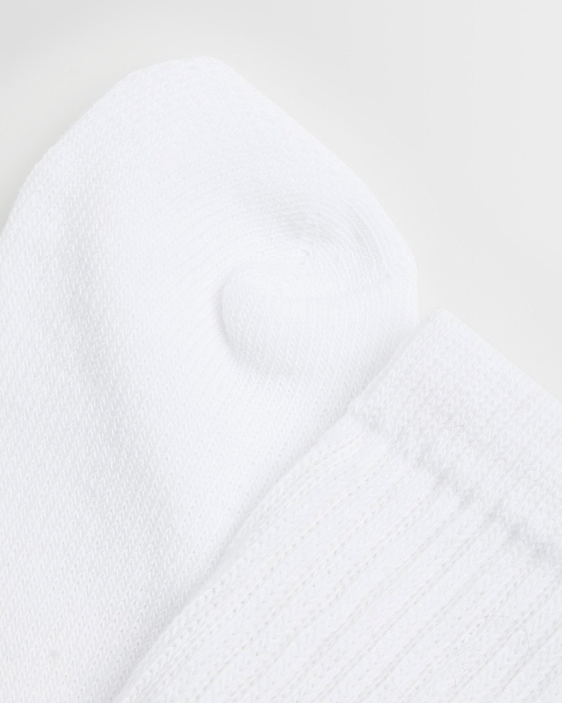 Close up of a single white sock with an elasticated support leg, cotton-rich fabric.