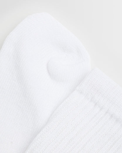 Close up of a single white sock with an elasticated support leg, cotton-rich fabric.