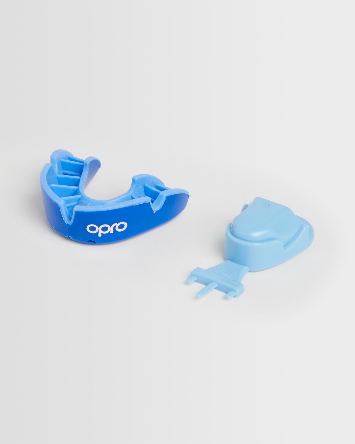 A blue OPRO mouthguard and its packaging on a white background.