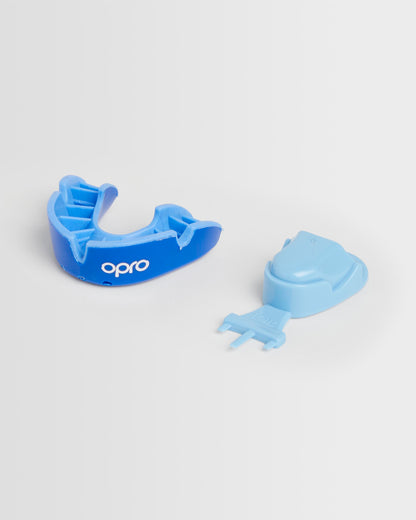 A blue OPRO mouthguard and its packaging on a white background.