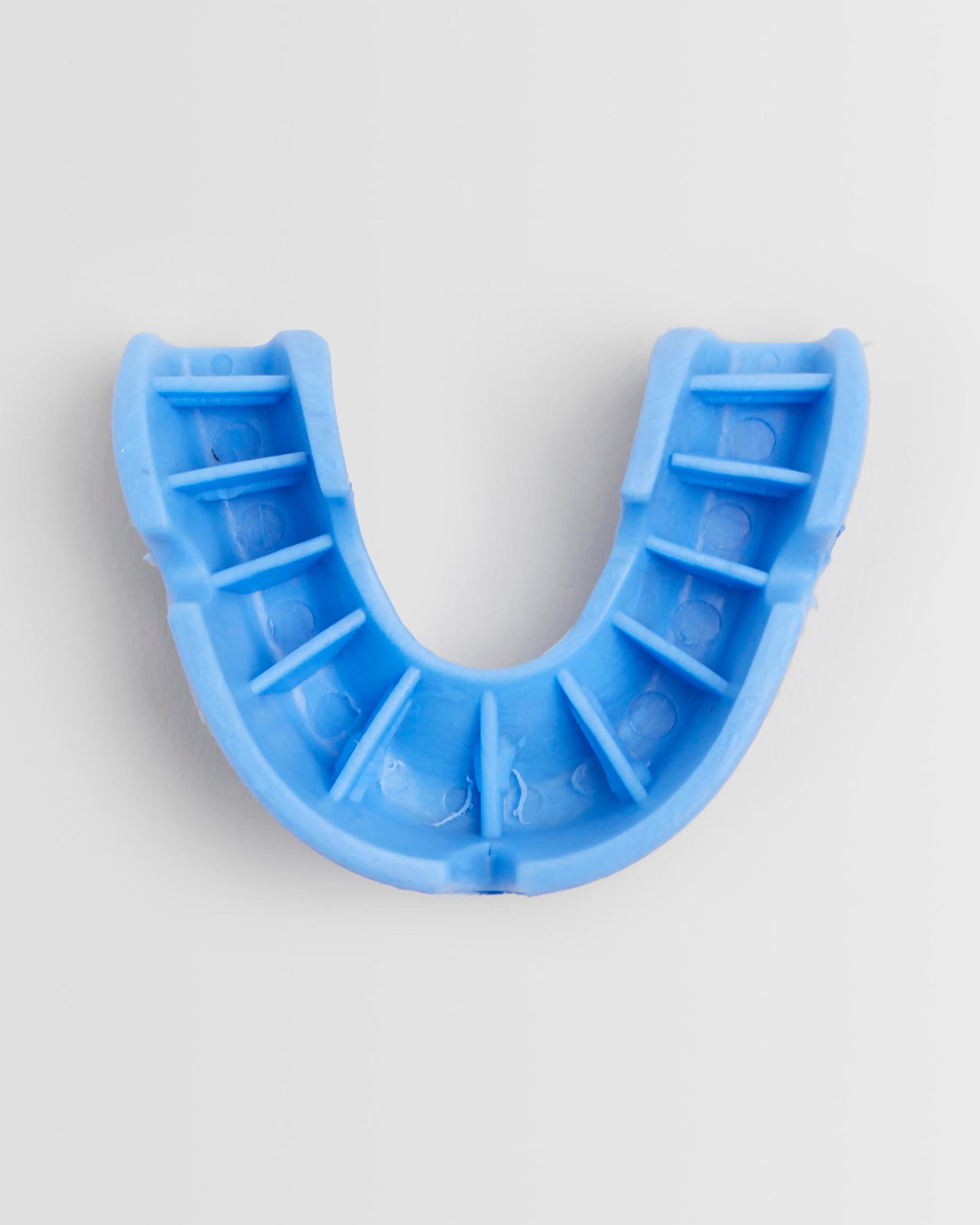 Top view of a blue OPRO mouthguard and its packaging on a white background.