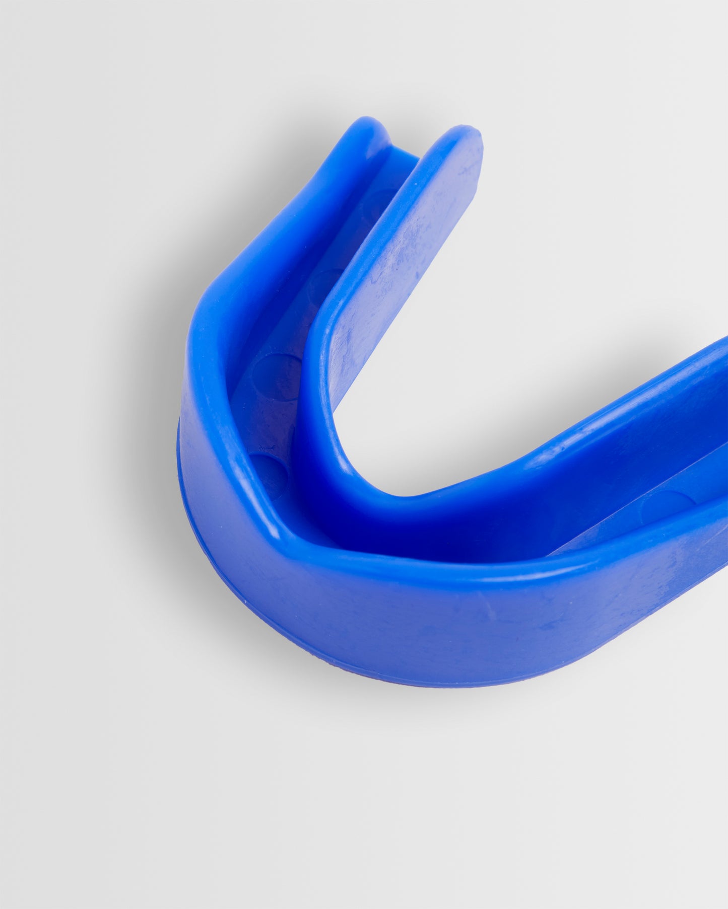A blue mouthguard designed for sports protection, displayed on a white background.