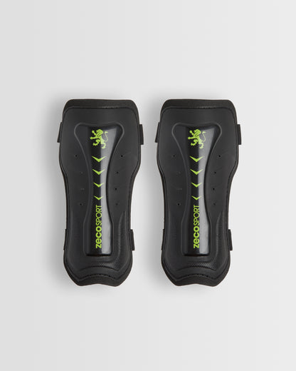 A pair of black shin guards with a visible logo in green.