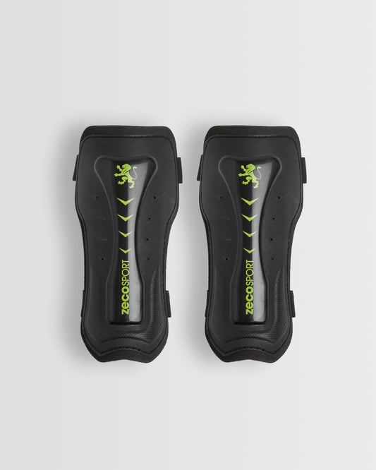 A pair of black shin guards with a visible logo in green.